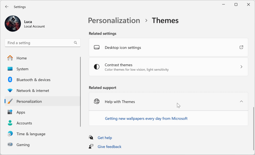 Select Desktop Icon Settings from the Related Settings menu under Themes